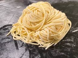 Nest of fresh handmade spaghetti dusted with semolina flour.